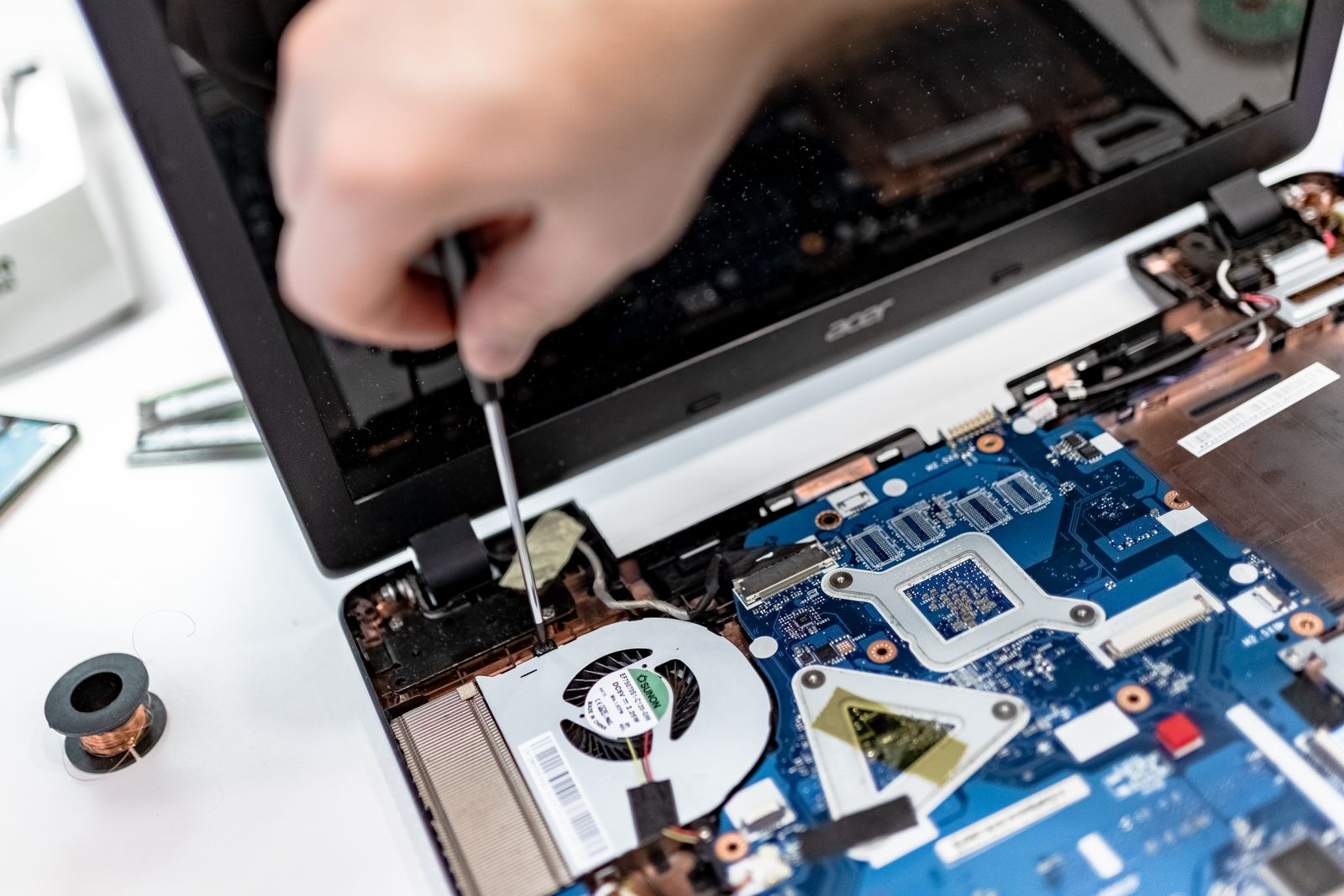 Technician inspecting the cooling system inside a laptop